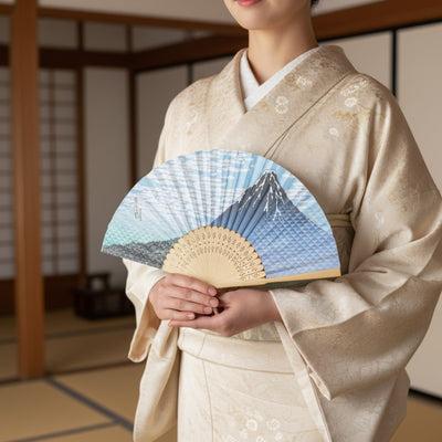 Refined traditional japanese folding fan featuring Mount Fuji design held by person wearing beige kimono in serene traditional interior with tatami mats