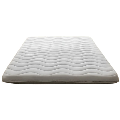 Comfortable white japanese futon with flowing wave pattern quilting displayed on clean white background showing traditional craftsmanship