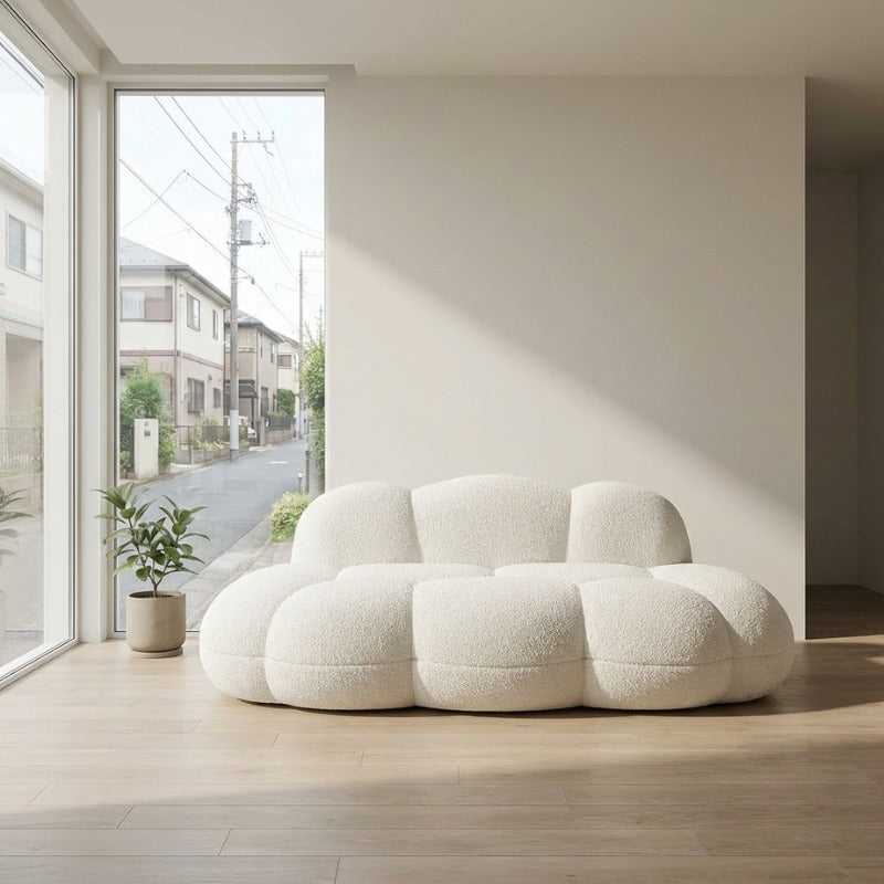 White japanese sofa with modular bubble design on light wood flooring near large window overlooking residential street
