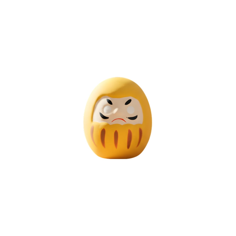 Financial success yellow japanese daruma in bright golden finish with blank eyes isolated on clean white background for clear product photography